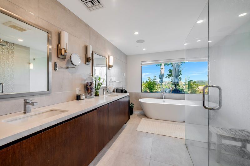 Primary bath with soaking tub and glass shower at 8545 Charl Lane, Hollywood Hills — photo 8 of 8