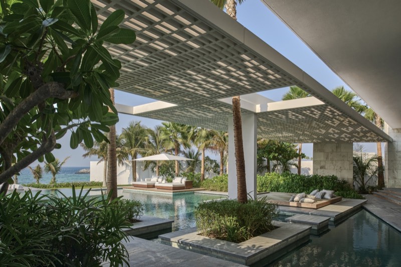 pool, white grid canopy, palms toward the Gulf